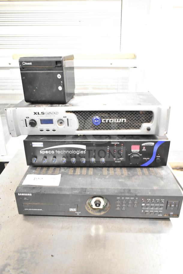 Four electronic devices: Toast TP200 printer, Crown XLS 1500 amplifier, Speco PBM120A amplifier, Samsung SRD-852DN DVR, used condition.