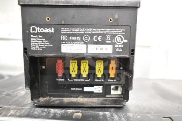 Toast TP200 receipt printer back panel with visible ports and compliance labels, featuring power, internet, and cash drawer connections.