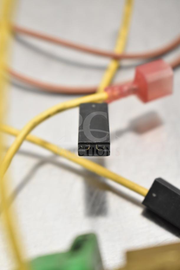 Close-up of electrical connectors with yellow and red wires, possibly part of a gauge system, emphasizing details and condition.