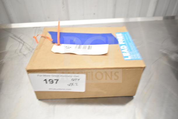 Cardboard box with safety seal tag, labeled "Lead Free" and auction tag number 197, containing Watts valve.