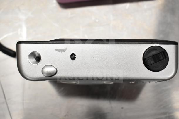 Silver VF201 film camera with buttons and dials visible; well-maintained condition.