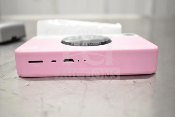 Kodak Printomatic pink 8mm camera, featuring Micro SD slot and USB port, in used condition.