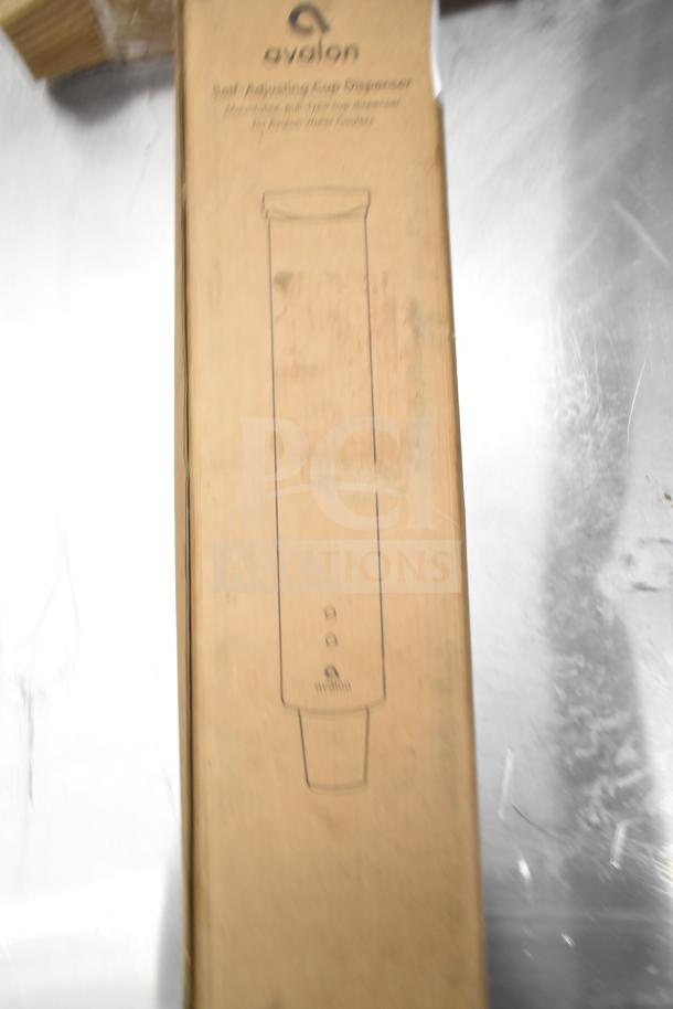 Brand new Avalon self-adjusting cup dispenser in box, suitable for Avalon water coolers; includes filter cartridges.