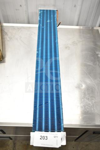 Blue evaporator coil with fins, in excellent condition, on a metal surface. Auction tag number 203 is visible.