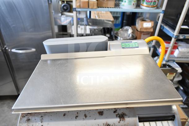 Mettler Toledo countertop food portioning scale, stainless steel, tested and working, with digital display and control panel.