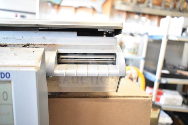 Mettler Toledo countertop food portioning scale, tested and working. Visible wear on casing; label printing feature shown.