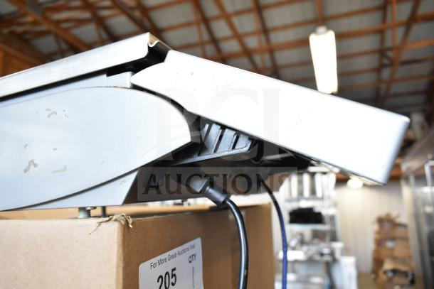 Mettler Toledo countertop food portioning scale, metallic finish, visible power cable, tested and working condition.