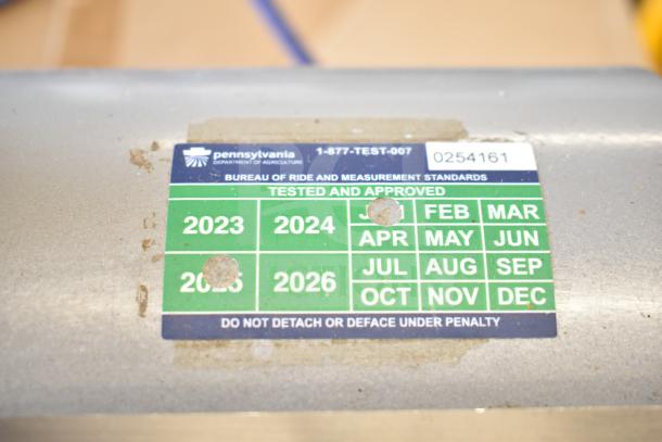 Mettler Toledo countertop food portioning scale with Pennsylvania inspection tag, tested and approved, model 0254161.