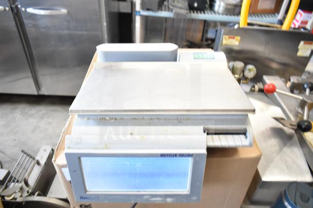 Mettler Toledo countertop food portioning scale, tested and working, no power cord. Features digital screen and stainless platform.