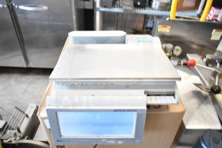 Mettler Toledo countertop food portioning scale, tested and working, no power cord. Features digital screen and stainless platform.