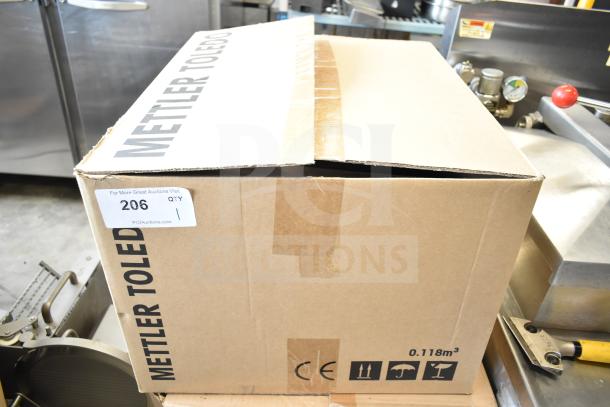 Mettler Toledo Countertop Food Portioning Scale in box, no power cord, tested working. Box shows brand and CE markings.