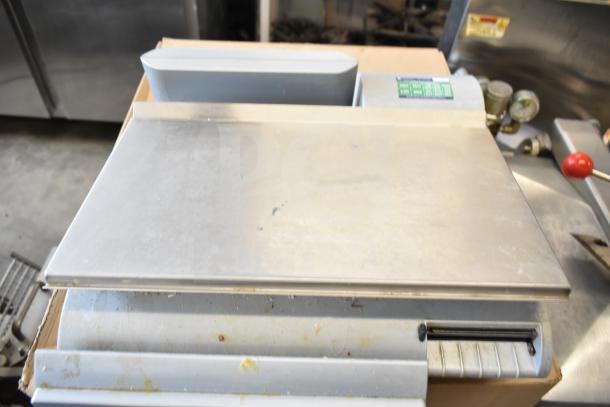 Mettler Toledo countertop food portioning scale, stainless steel surface, visible controls, no power cord, tested working condition.