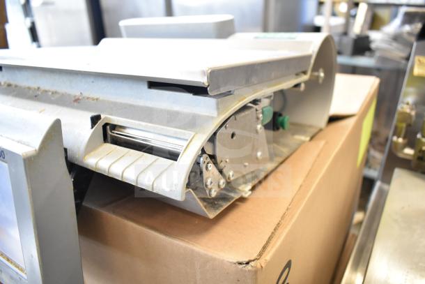 Mettler Toledo countertop food portioning scale, tested and working, without power cord, metal finish, visible control panel.