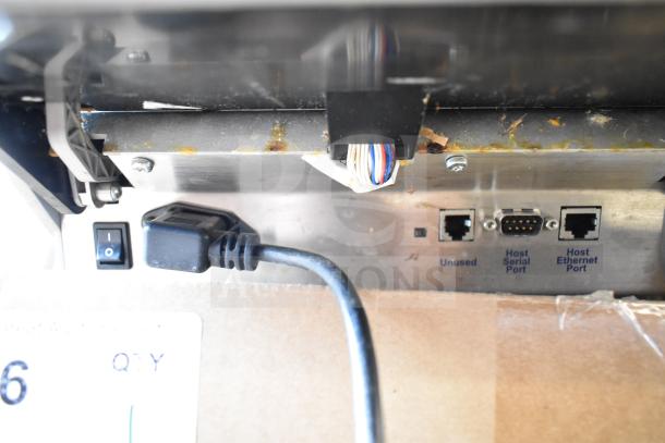 Mettler Toledo food portioning scale, countertop model. Lacks power cord. Includes host serial and Ethernet ports. Tested working.