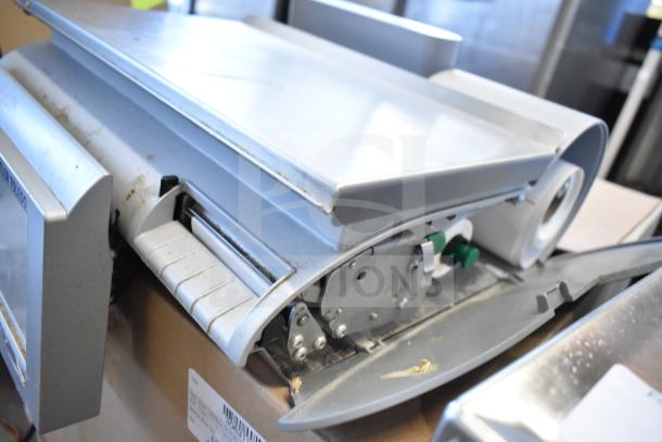 Mettler Toledo countertop food portioning scale, tested and working, without power cord. Visible wear, stainless steel surface.