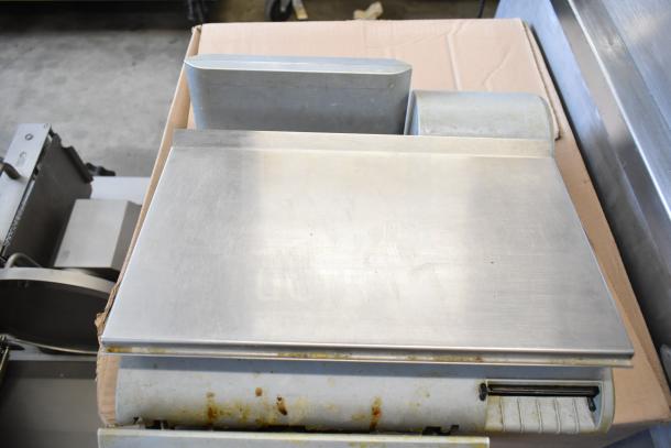 Mettler Toledo countertop food portioning scale without power cord; tested and does not power on. Stainless steel surface.