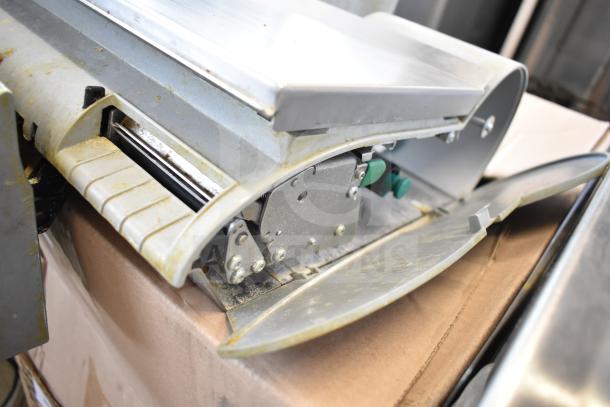 Mettler Toledo countertop food portioning scale in worn condition, missing power cord, does not power on, metal finish.