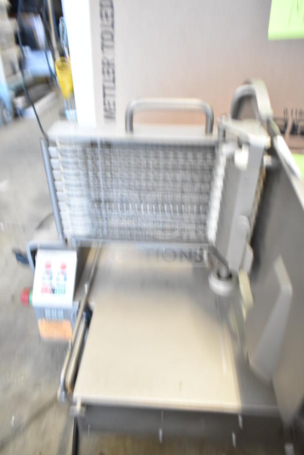 Jaccard VA2000GRT Commercial Automatic Meat Slicer, countertop model. 110V, 1 phase. Slightly blurry image, no visible labels.