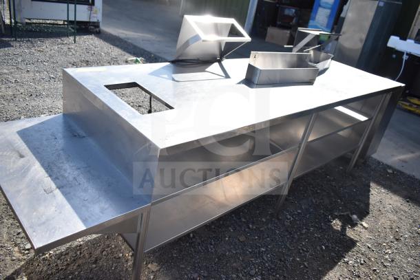 Stainless steel commercial table with two under shelves, featuring a cutout section and a side extension.