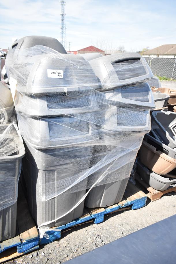 Five gray poly trash cans with extra lids, wrapped on a pallet; excellent condition, auction lot tag visible.