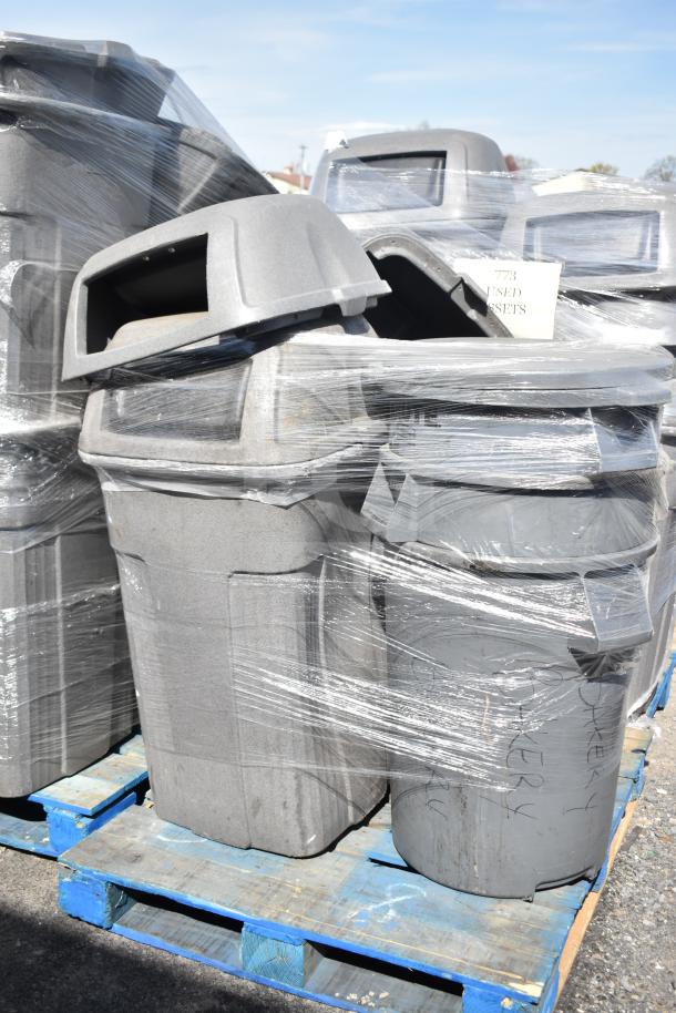 Six gray poly trash cans with extra lids, various sizes, shrink-wrapped on a pallet, labeled for auction lot 773.