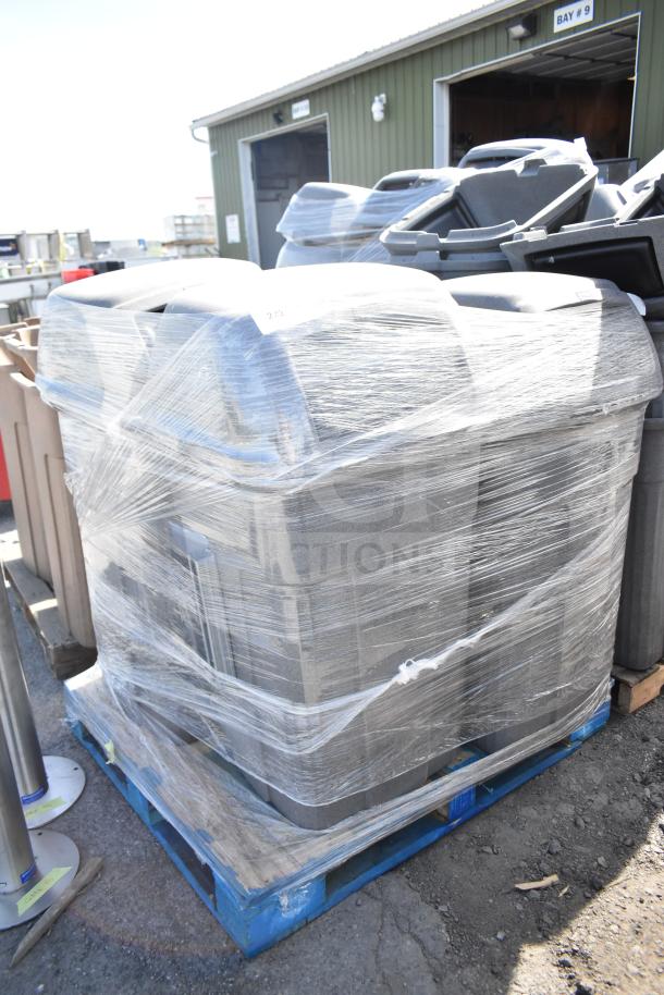 Four gray poly trash cans wrapped in plastic on a pallet, indicating bulk sale for auction.