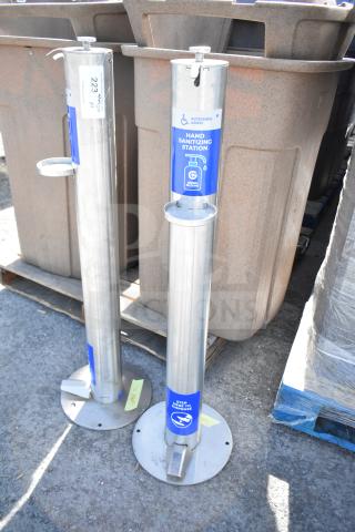 Two stainless steel hand sanitizing stations with foot pedal operation, blue signage, and accessible design.