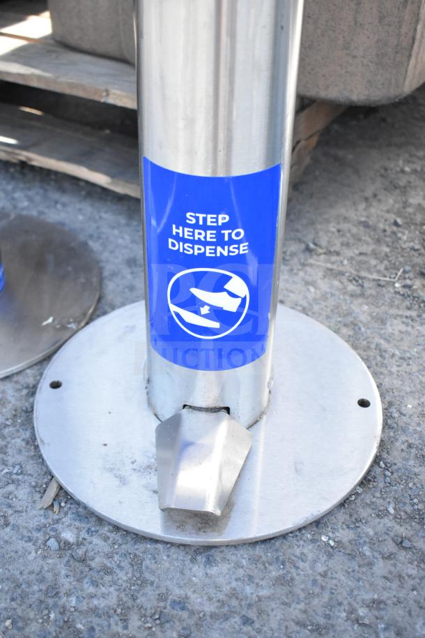 Stainless steel hand sanitizing station with foot pedal, blue "Step Here to Dispense" label, durable and freestanding.