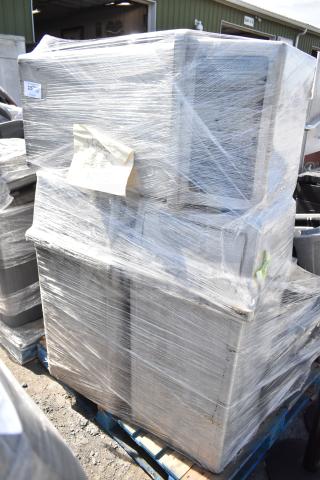 Six stacked gray poly trash cans, wrapped in clear plastic on a pallet.