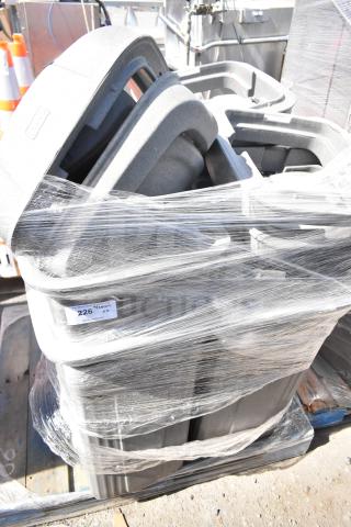 Bundle of 6 gray poly trash cans, stacked and shrink-wrapped on a pallet. Auction tag "226." Good condition.