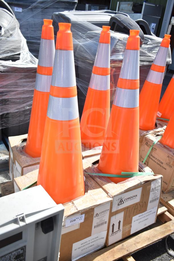 4 new Boen CTC36R 36" orange PVC reflective traffic safety cones. Scratch and dent. On a pallet with boxes marked Cordova.