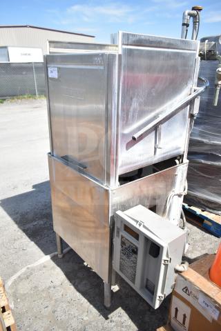 Hobart AM-14 commercial pass-through dishwasher, stainless steel, visible brand marking, outdoor setting.
