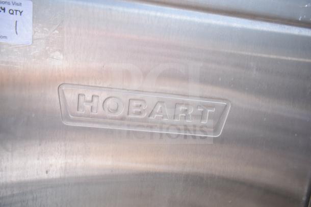 Hobart AM-14 commercial pass-through dishwasher, stainless steel, embossed logo. Suitable for heavy-duty use.