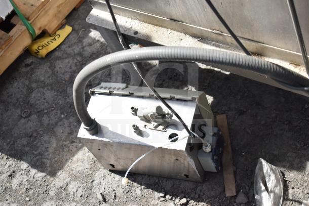 Hobart AM-14 commercial dishwasher component, hoses attached, in outdoor setting. Visible wear, used condition.