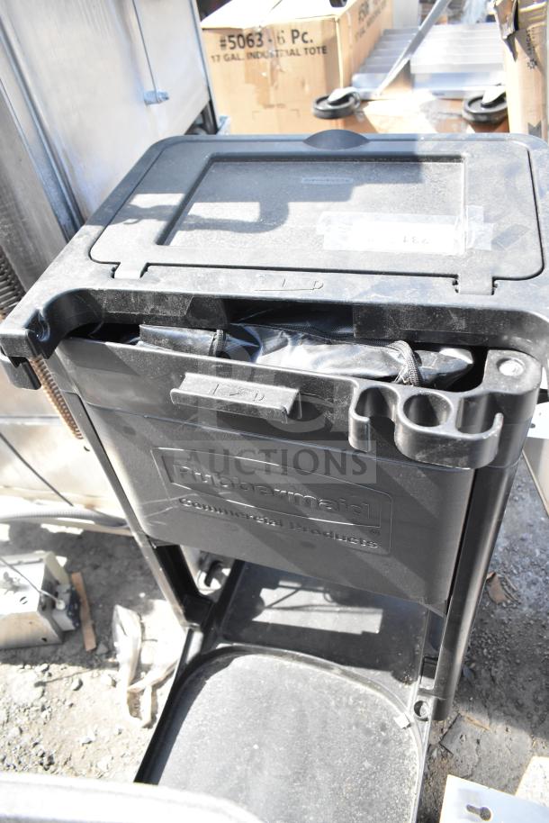 Rubbermaid black poly janitor cart on casters, includes storage compartments and tool holders, visible wear, labeled "Rubbermaid Commercial Products."