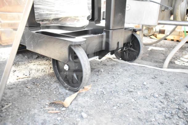 Rubbermaid black poly janitor cart on casters, showing sturdy wheels and base. Ideal for commercial cleaning tasks.