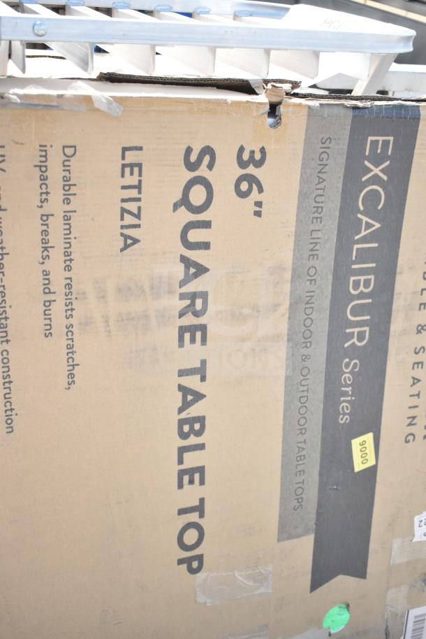 Cardboard box for 36" Excalibur Series square tabletop, Letizia model, scratch-resistant, with visible dents and markings.