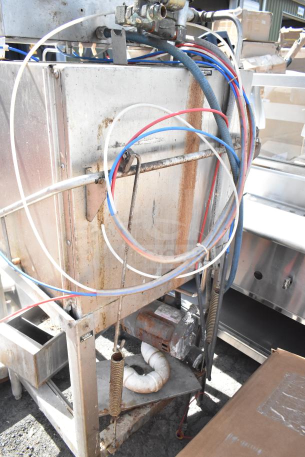 CMA AH-2 commercial straight pass-through dishwasher with visible wires and rust, model tag, and pipe connections.