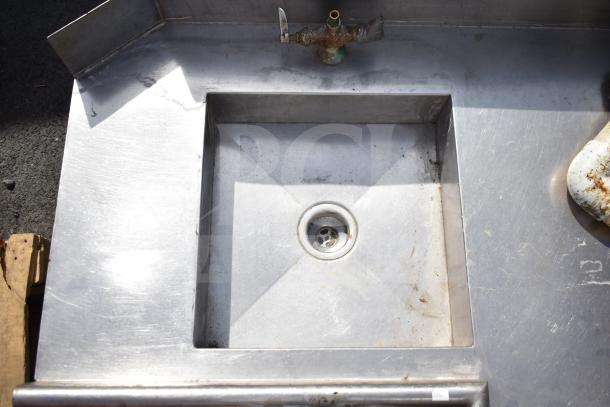Stainless steel right side dirty side dishwasher table with integrated sink and faucet, showing signs of wear.