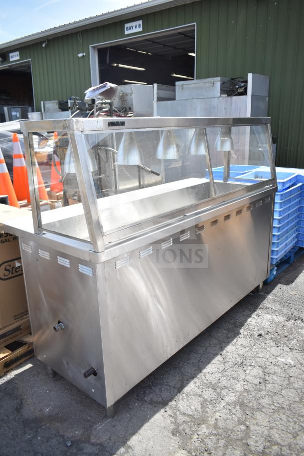 Stainless steel commercial hot food merchandising case, glass front, multiple heat lamps, used condition, suitable for food display.
