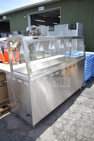 Stainless steel commercial hot food merchandising case, glass front, multiple heat lamps, used condition, suitable for food display.