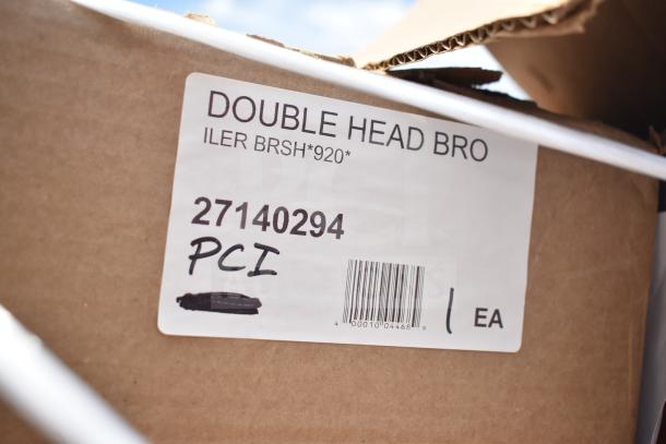 Label on cardboard box reading "DOUBLE HEAD BRUSH," with code "27140294 PCI" beneath, barcode, and quantity "1 EA."