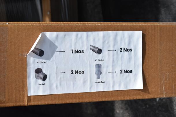 Cardboard box with a label showing components: 30 Dia leg, 40 Dia leg, socket, plastic feet. Each part with quantities.