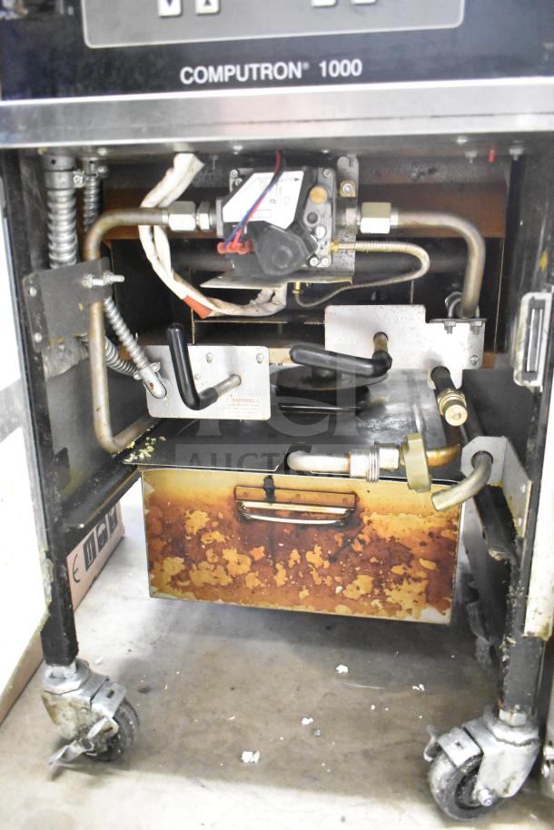 2023 Henny Penny 600 pressure fryer, natural gas, 80,000 BTU, with commercial casters. Visible wear on lower cabinet.