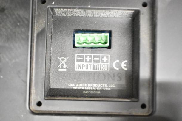 QSC AD-S6T speaker connection panel showing input labels and CE marking. Made in China.