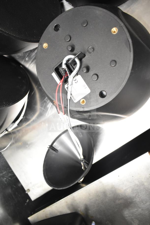 Eight speakers including QSC AD-S6T and Crestron SAROS PD6T-B-T-EACH, visible wiring and mounts, used condition.