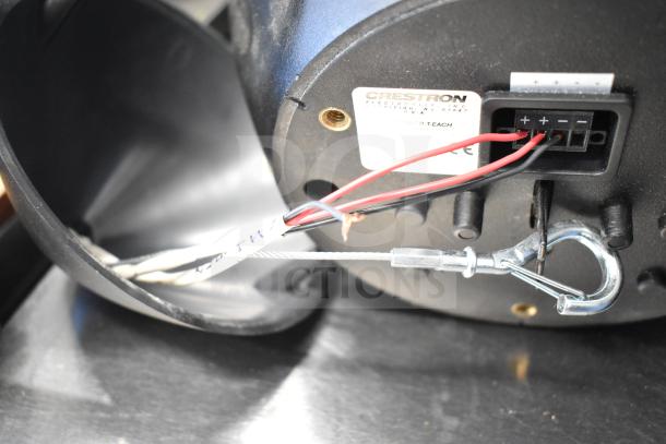 Rear view of a Crestron SAROS PD6T-B-T-EACH speaker showing wiring connections and label for model identification.