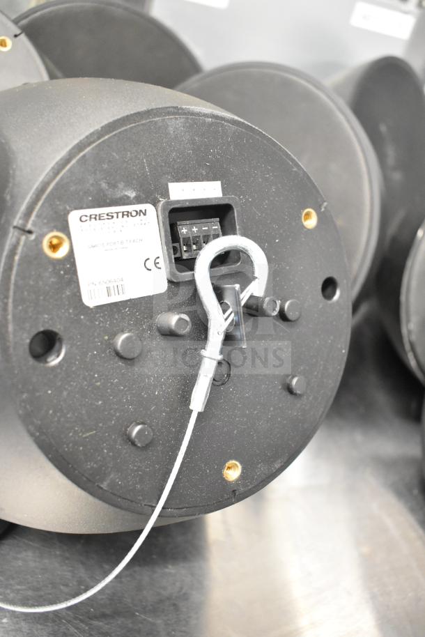 Eight speakers, including one QSC AD-S6T and seven Crestron SAROS PD6T-B-T-EACH. Features visible wiring and connectors.