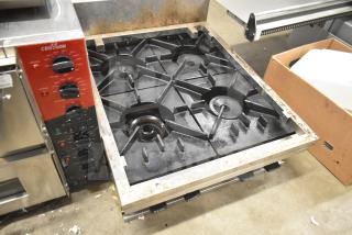 Commercial countertop 4-burner range, natural gas powered, well-used condition, corrosion on edges, Croson brand controls visible.