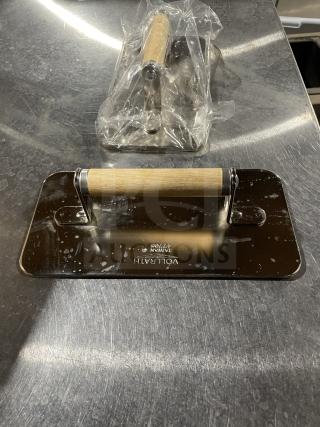 Brand new VollRath steak weight, model 47703, stainless steel with wood handle. Engraved logo and model number visible.